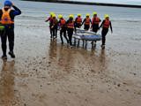The group taking their paddle board out to sea