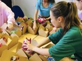 Young people creating afternoon tea packs