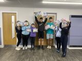 Group holding up the mental health packs they created