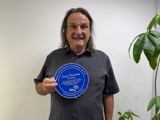 Tom smiling with a plaque