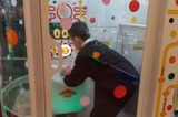 One of the young people playing on the ball grabber game