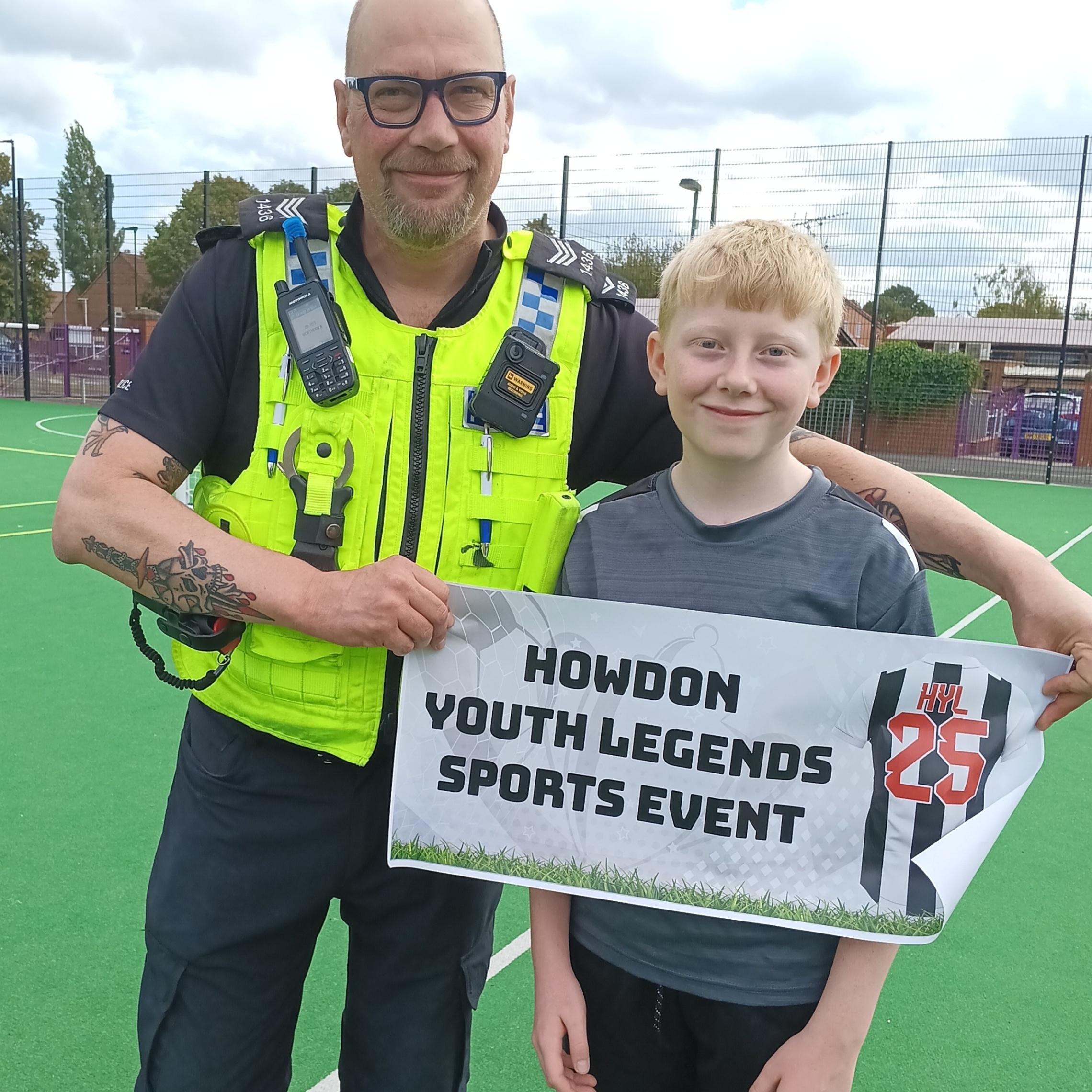 Police officer and young person with event sign