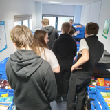 The group looking at boxes of food