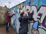 Young people painting outside