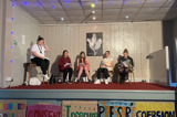 The group onstage, in character