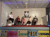 The group onstage, in character
