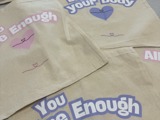 Slogan tote bags that say "you are enough"