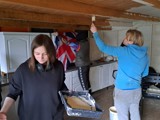 Two people from the group painting the allotment kitchen 